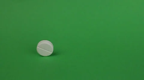 Tablet are rolling on a green background Video stock 25877397