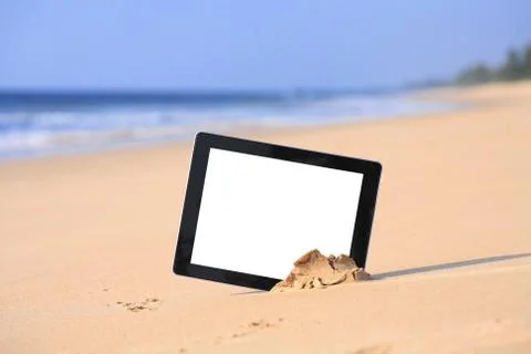 Tablet on the beach Stock Photos