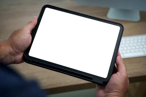 Tablet with blank screen mockup held in hands, perfect for showcasing app d.. Stock Photos