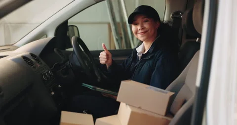 Tablet, boxes and face of woman in van with thumbs up, logistics or distribution Stock Footage 341576569