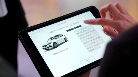 Tablet, business ideas, test drive for the car dealership. BMW Stock Footage 107909308