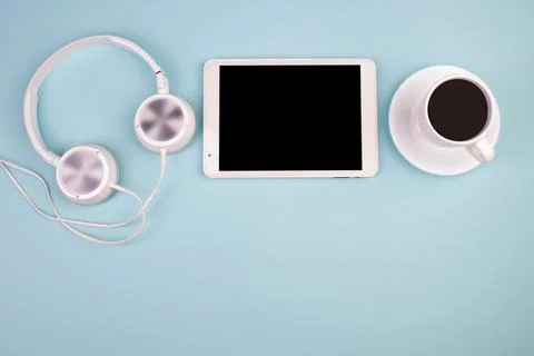 Tablet, calculator, phone, pen and a cup of coffee, lot of things on a blue.. Stock-Fotos