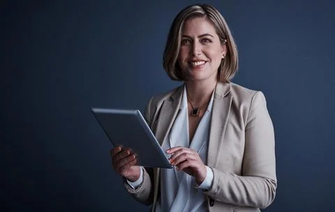 This tablet can do everything. Studio portrait of an attractive young corporate Stock Photos
