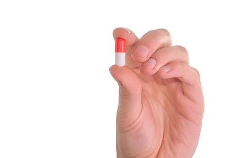 Tablet capsule is held in the hand with your fingers Stock Photos