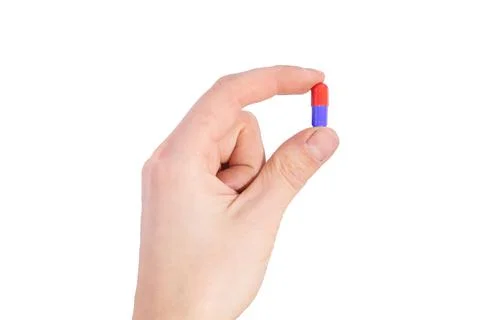 Tablet capsule is held in the hand with your fingers Stock Photos