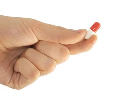 Tablet capsule is held in the hand with your fingers Stock Photos