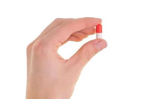 Tablet capsule is held in the hand with your fingers Stock Photos