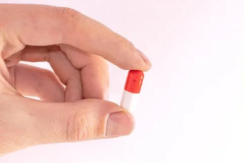 Tablet capsule is held in the hand with your fingers Stock Photos