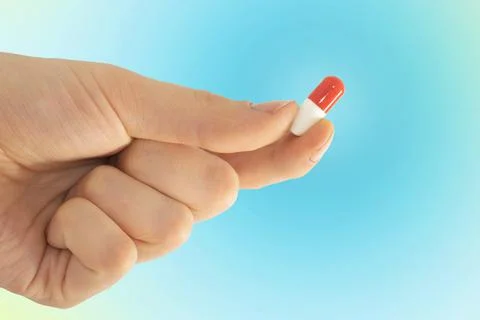 Tablet capsule is held in the hand with your fingers Stock Photos