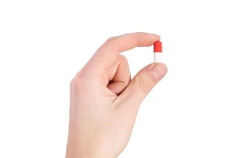 Tablet capsule is held in the hand with your fingers Stock Photos