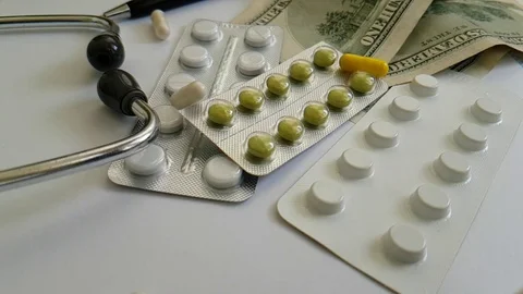 Tablet capsules are falling dollars Stock Footage 88494389