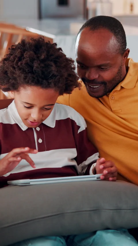 Tablet, child and dad with game on sofa for online puzzle, problem solving or Stock Footage 338425620