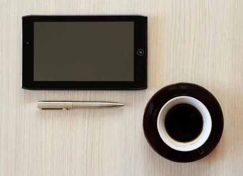 Tablet with coffee on table Stock Photos