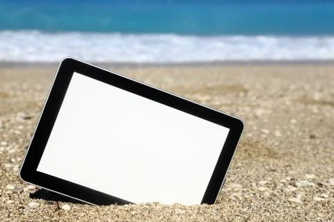 Tablet computer on the beach Stock Photos