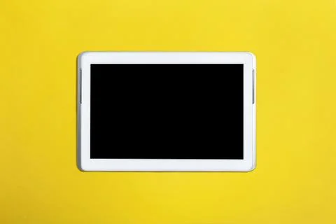 Tablet computer with black screen isolated on yellow surface Stock Photos