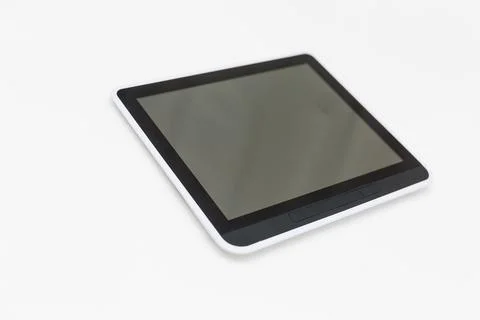 Tablet computer with blank screen mockup lies on the surface, isolated on white Stock Photos