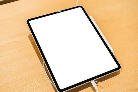 Tablet computer with blank screen on wooden table Stock Photos