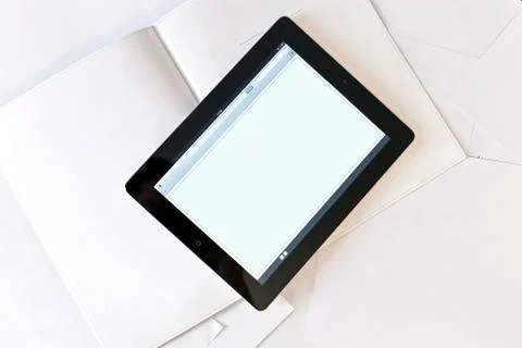 Tablet computer on book with blank pages Stock Photos