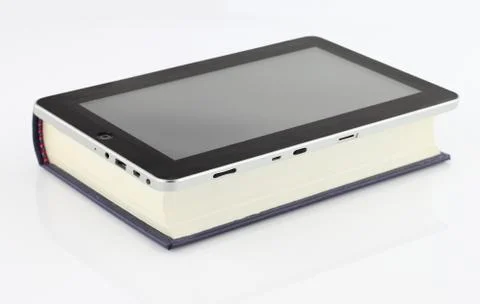 Tablet computer on book  isolated on white Stock Photos