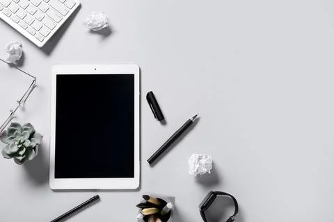 Tablet computer with crumpled paper, computer keyboard, smart watch and eyegl Stock Photos