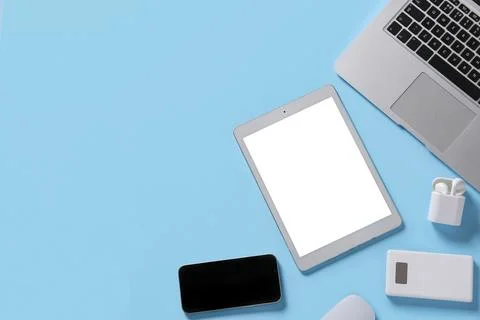 Tablet computer with different modern gadgets on blue background Stock Photos