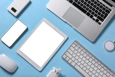 Tablet computer with different modern gadgets on blue background Stock Photos