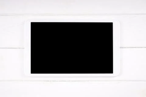 Tablet computer with empty display on white wood Stock Photos