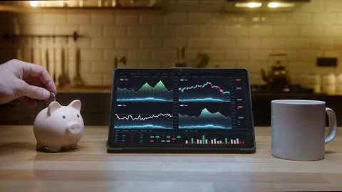 Tablet computer with financial charts on screen standing on the kitchen tab.. Stock Footage 277228799
