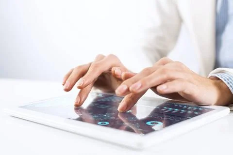 Tablet computer for financial data analysis Broker in white suit using tab... Stock Photos