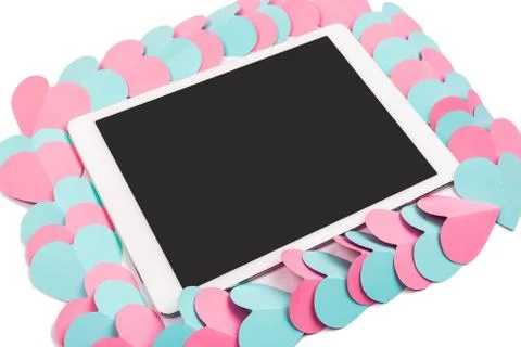 Tablet computer framed with paper hearts isolated on white background Stock Photos