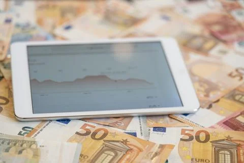 Tablet computer with graphics on the screen on Euro banknotes Stock-Fotos
