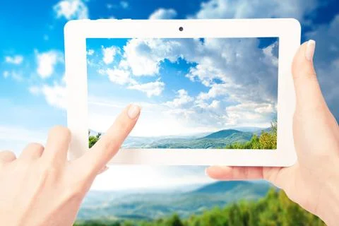 Tablet computer in hand on the forest backgrounds Stock-Fotos