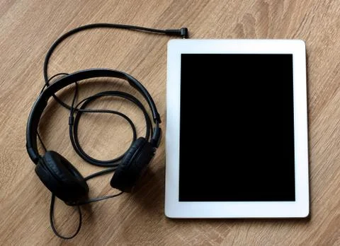 Tablet computer with headphones Stock Photos