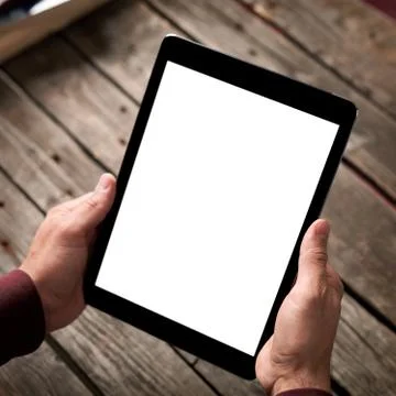 Tablet computer with isolated screen in male hands 写真素材