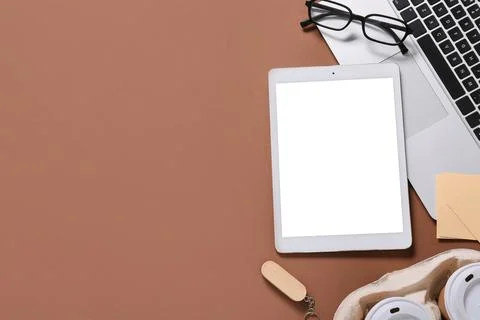 Tablet computer with laptop, takeaway cups of coffee, USB flash drive and eye Stock Photos