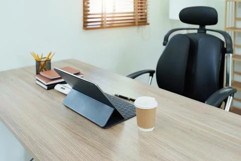 Tablet computer, notebook, calculator and coffee cup on the desk in the office Stock Photos