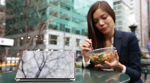Tablet computer pc and business woman eating salad Stock Footage 35432711
