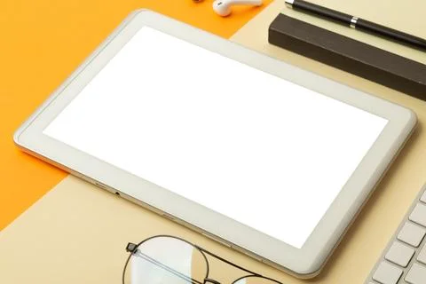 Tablet computer screen mockup with clipping path and wireless earphones, no.. Stock Photos