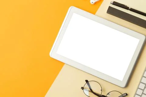 Tablet computer screen mockup with clipping path and wireless earphones, no.. Stock Photos