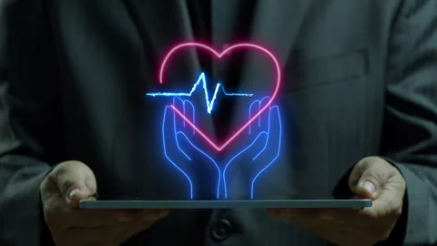 Tablet computer showing neon line of hands holding red heart with blue pulse Stock Footage 280888602