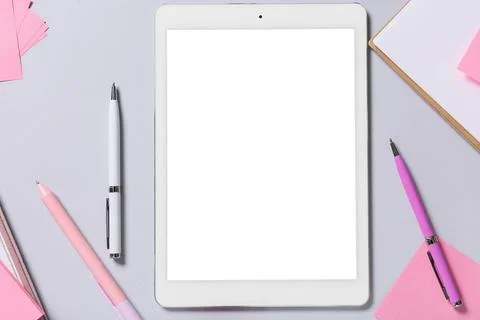 Tablet computer with stationery on grey background Stock Photos