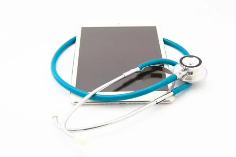 Tablet computer with  stethoscope, isolated on white background Stock Photos
