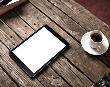 Tablet computer on table with cup of coffee 写真素材