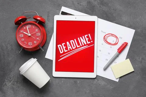 Tablet computer with word DEADLINE, calendar, alarm clock and coffee cup on d Stock Photos