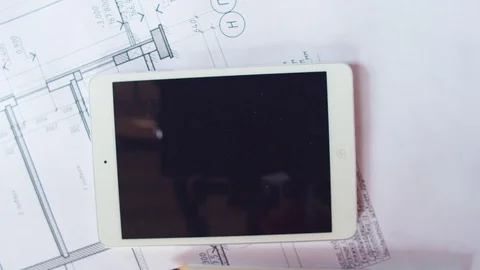 Tablet on construction drawings, top view Stockbeeldmateriaal 74182975