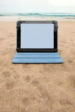 Tablet device on beach Stock Photos