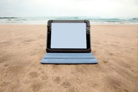 Tablet device on beach Stock Photos