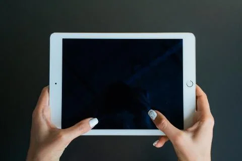 Tablet device, black screen on gray background Stock Photos