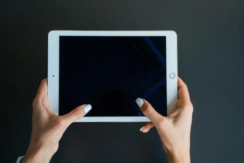 Tablet device, black screen on gray background Stock Photos