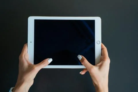 Tablet device, black screen on gray background Stock Photos